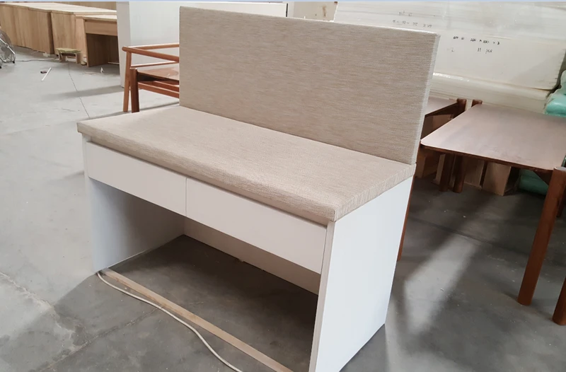 Woven vinyl banquette seat and back panel being assembled on a timber frame