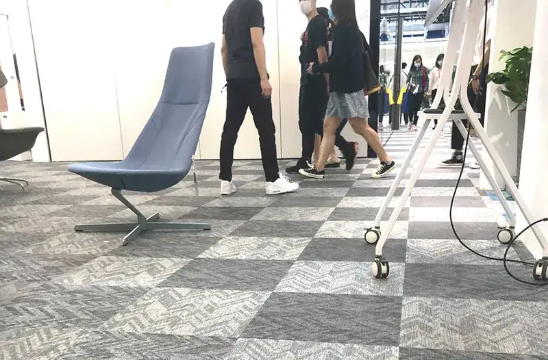 Public concourse floor in woven vinyl acoustic modular carpet tiles